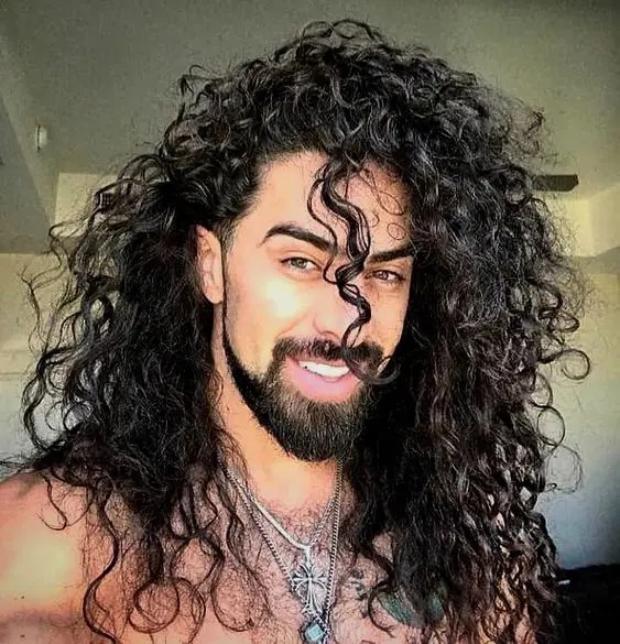 Man showing off his breathtaking curly hair with a smile