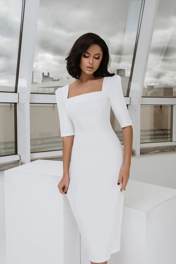 Woman wearing a square neck white dress as a casual wedding dress