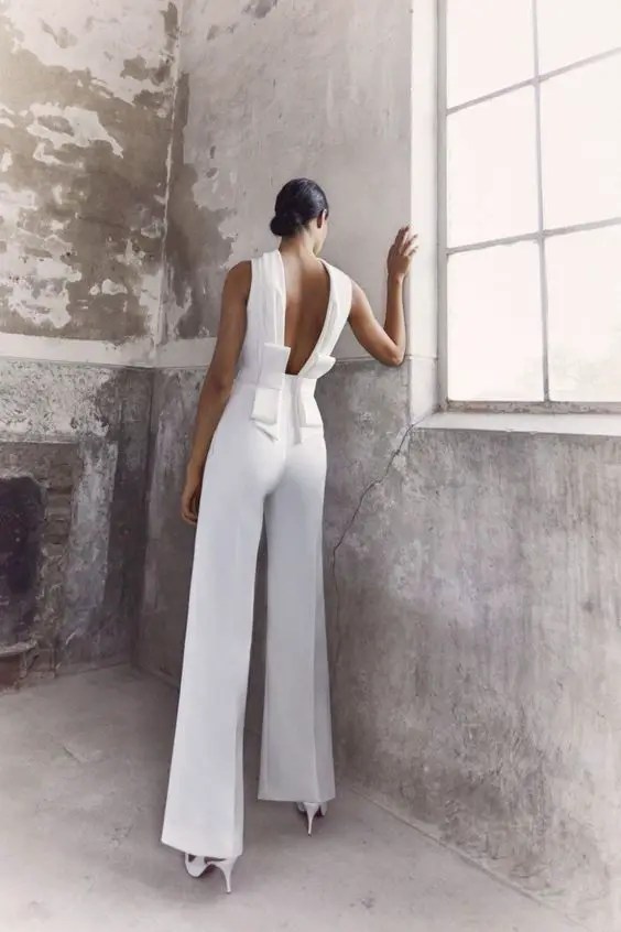 backview of bride in chic white jumpsuit