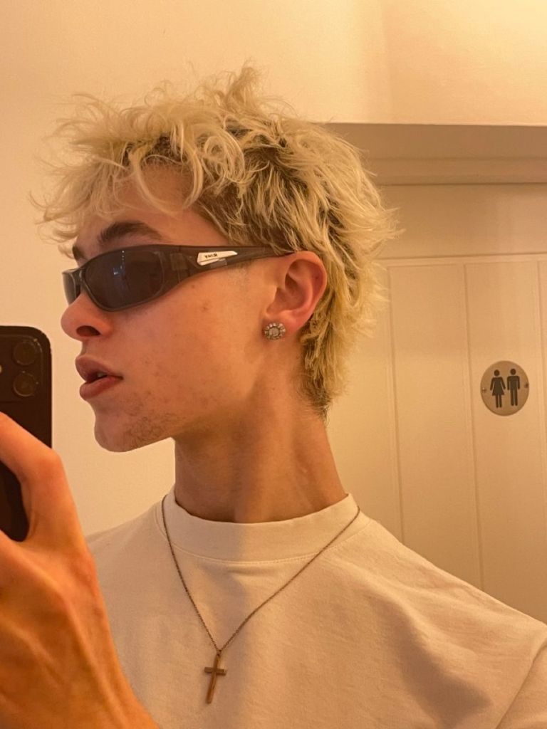 Man wearing blond wolf cut with sunglasses