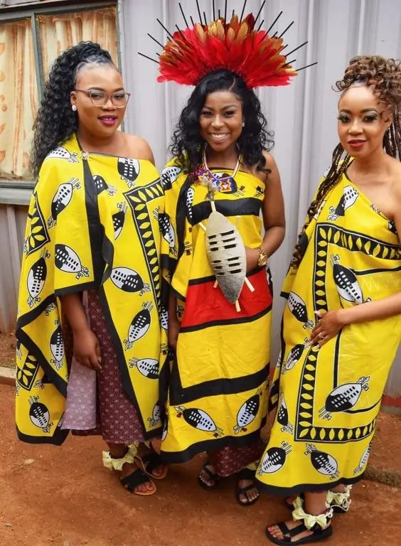 Three women in traditional Swazi costumes