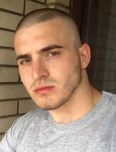 man in t-shirt with military buzz haircut
