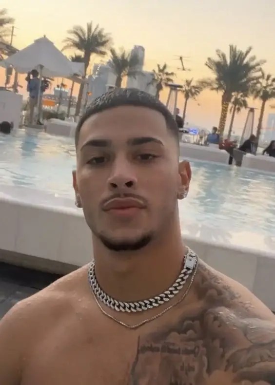 Cute man wearing a chain and showing his hairstyle