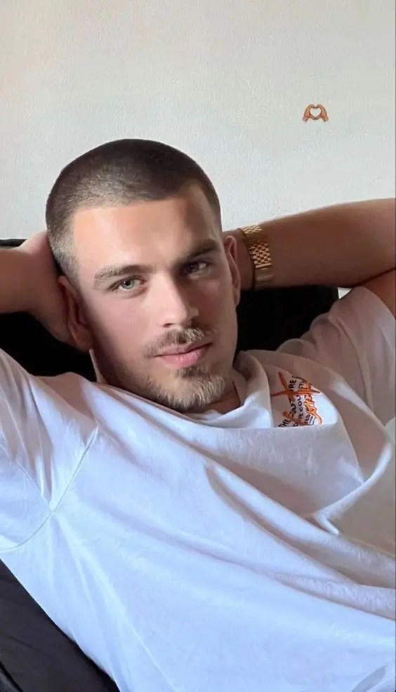 A man relaxing in his chair and showing off his haircut