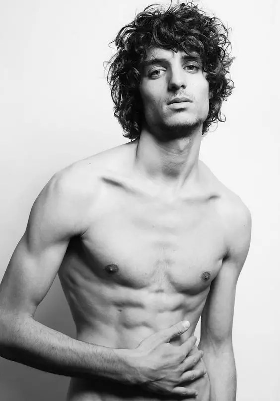 Naked man showing off his disheveled male wolf cut
