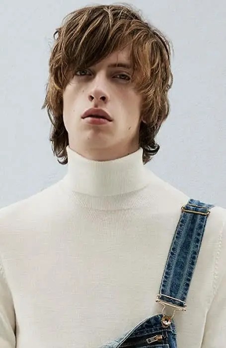 man in turtleneck wearing blond wolf cut