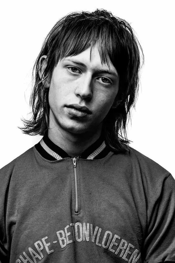 Man with disheveled cut and curtain bangs