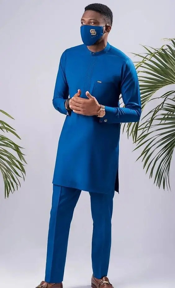A man wearing a caftan with a nose mask