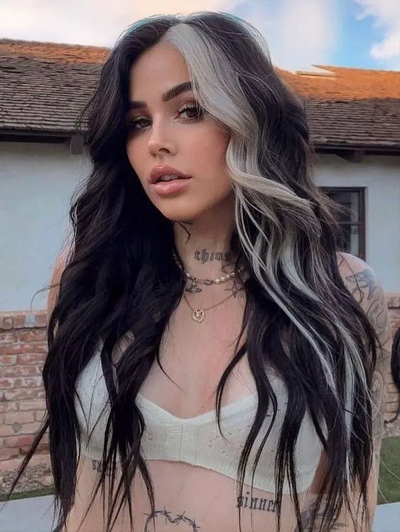 Wavy black hair with streaks of platinum blonde