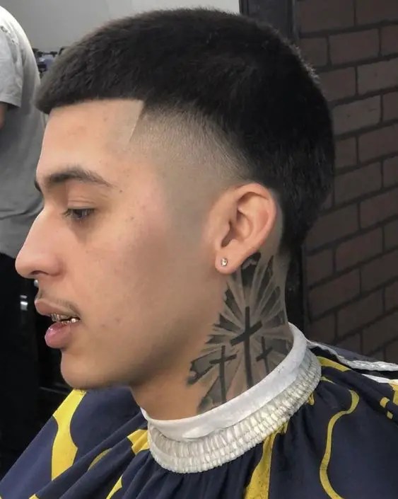 Man with tattoo on neck with tak ash haircut