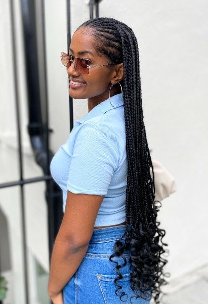 Smiling woman with sunglasses wearing long braids