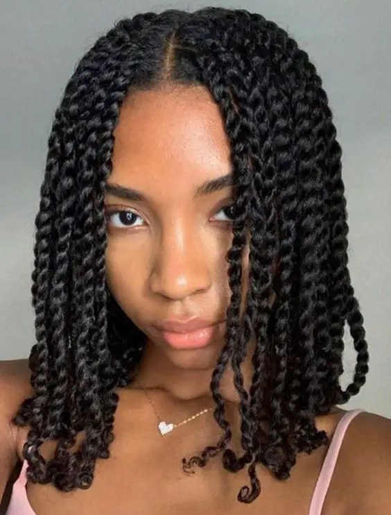 A woman wearing a shoulder-length natural twist style