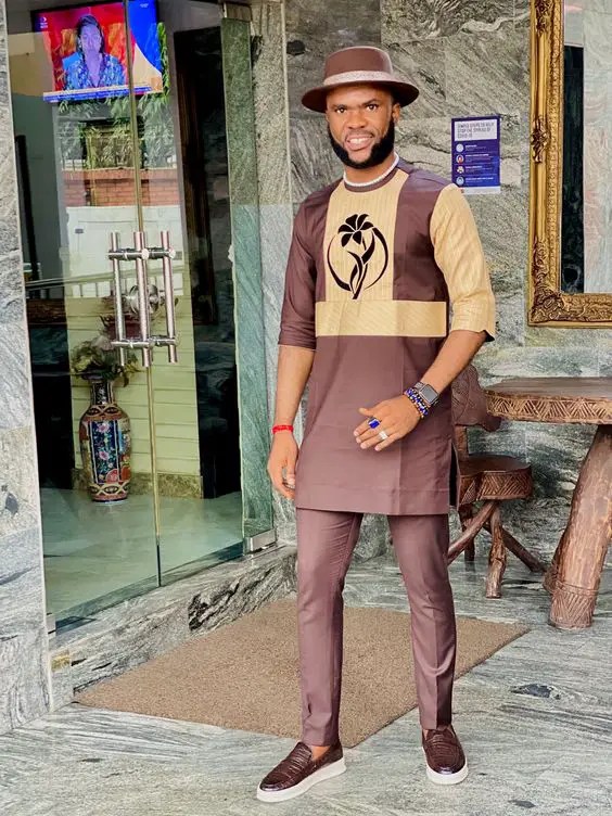 Man wearing a brown mixed caftan style for men with a hat
