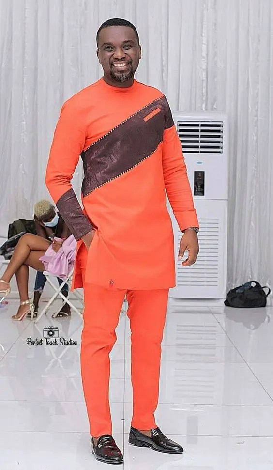 man wearing orange long sleeve senator