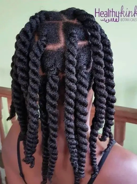 A woman wearing a thick long rope-like braid