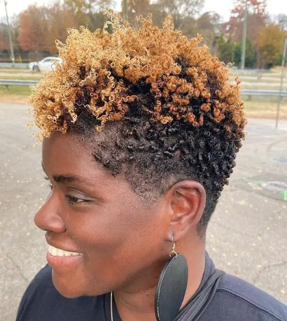 Smiling woman wearing black and blonde natural hair