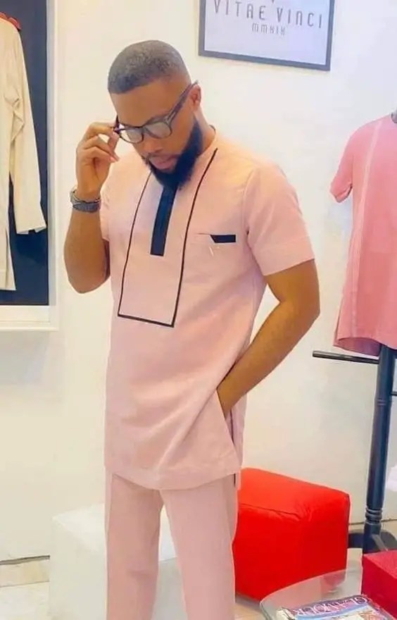 man wearing baby pink kaftan style for men