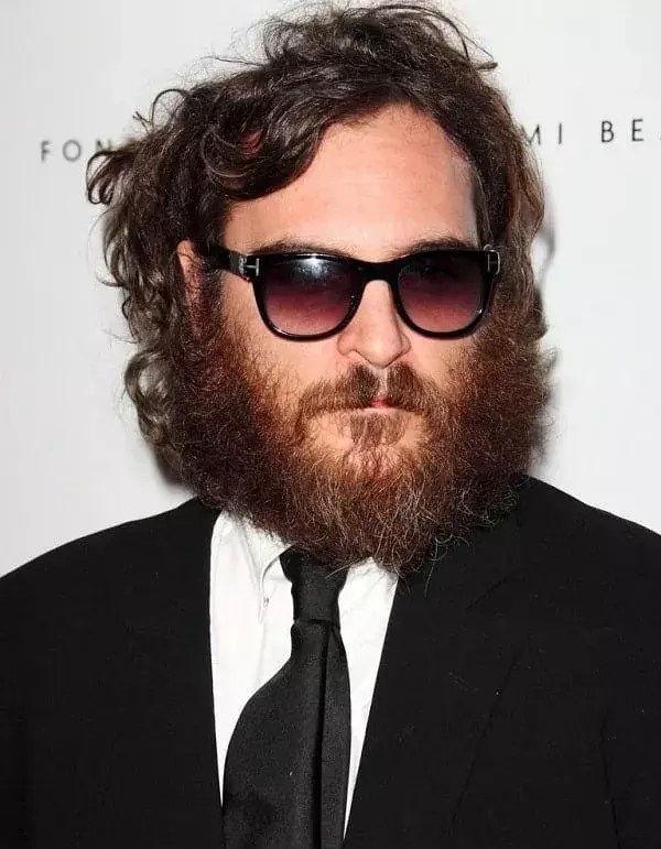 A man wearing glasses that rocks the no-maintenance look.