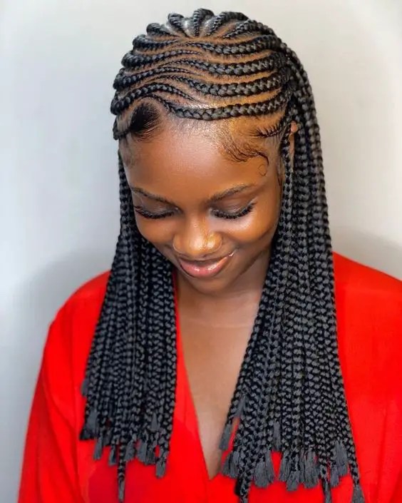 Smiling woman wearing intricately patterned Ghana weave style