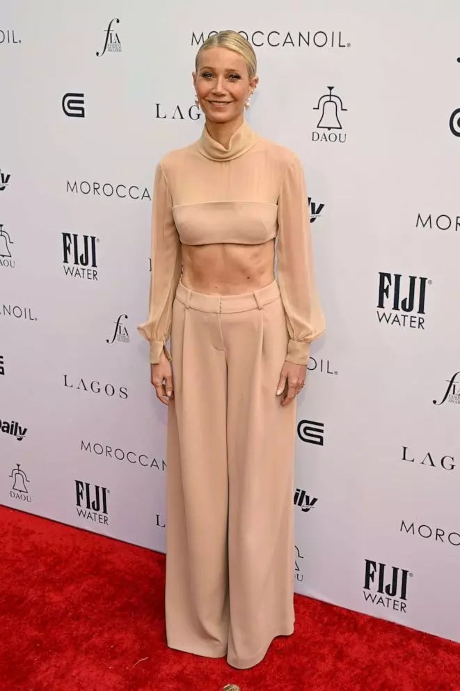 Gwyneth Paltrow bought her fashion game and showed off her midriff while posing for the red carpet.