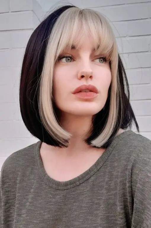 Woman wearing black hair and blonde bangs
