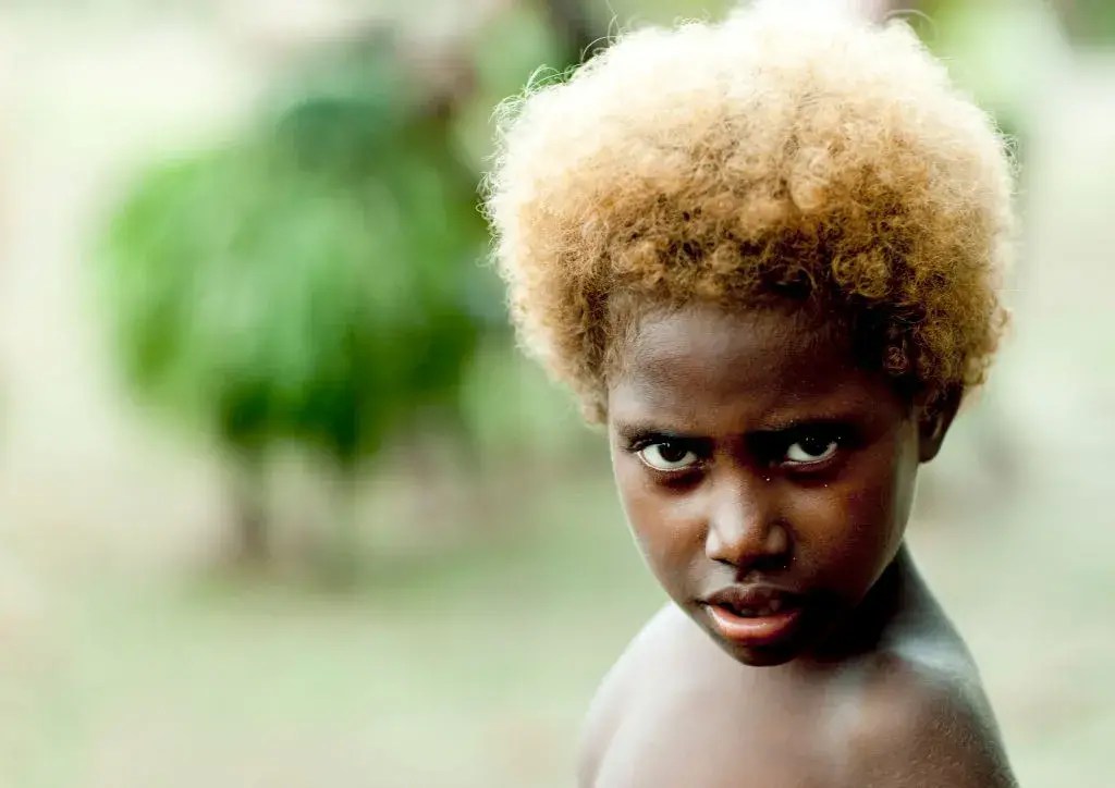Melanesian kid with blonde hair