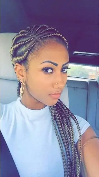 A woman who looks good with blonde extensions and a side-parted Ghana weave style