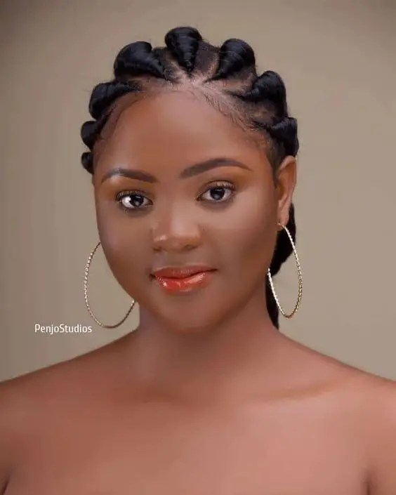 Innocent woman in thick ghana woven cornrows