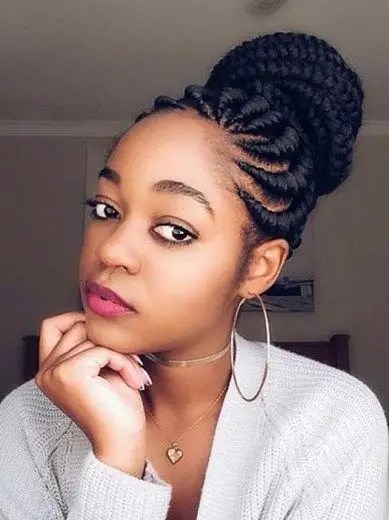 Woman rocking a Ghana weave hairstyle wrapped in a bun