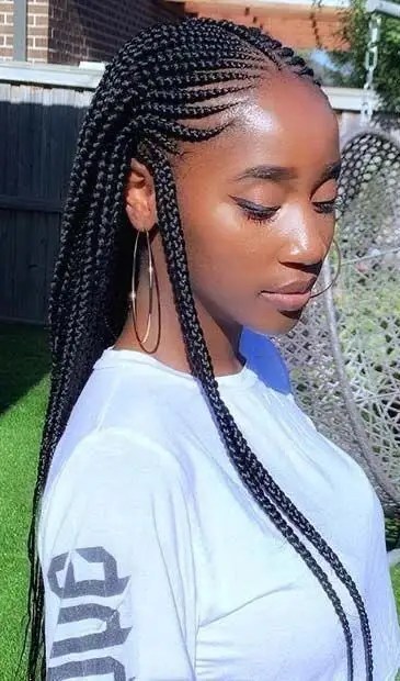 Lady rocking all-back Ghana weave style, side braid