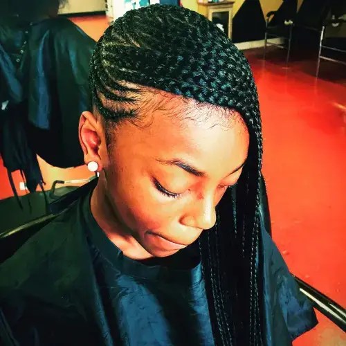 A beautiful woman rocking a side-swept Ghana braid.