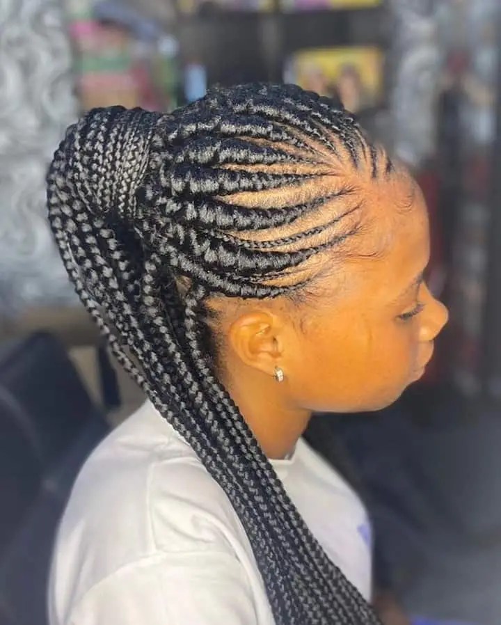 Woman rocking half-up Ghanaian braids