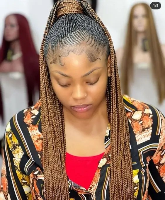 A woman rocking tiny Ghanaian braids.