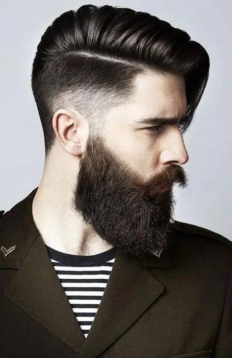 A man rocking his full beard sideways