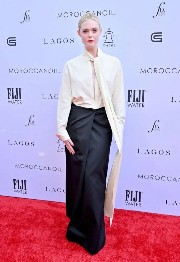 Elle Fanning looks stunning on the red carpet in a chic black and white ensemble.