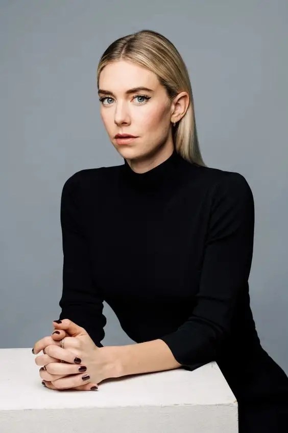 Beautiful actress rocks a black dress with middle-parted blond hair
