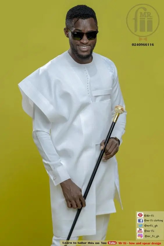 A man with a cane shaking Senator Agbada