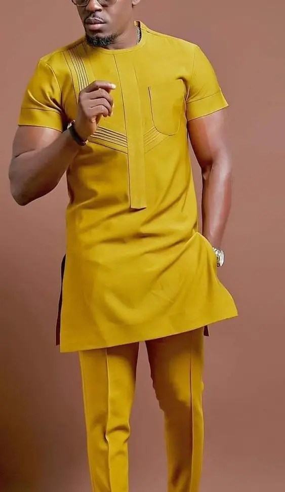 A man wearing an orange short-sleeved caftan