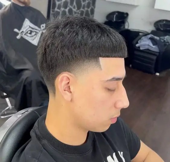 Cute man sitting on chair showing his haircut with fade