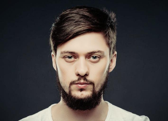 A man with a thin mustache and a beard all over his neck