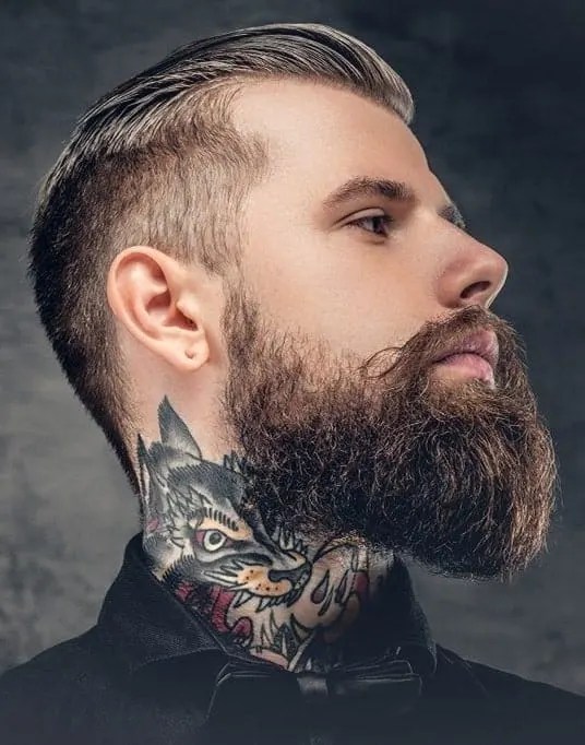 Profile of tattooed man with full neck beard