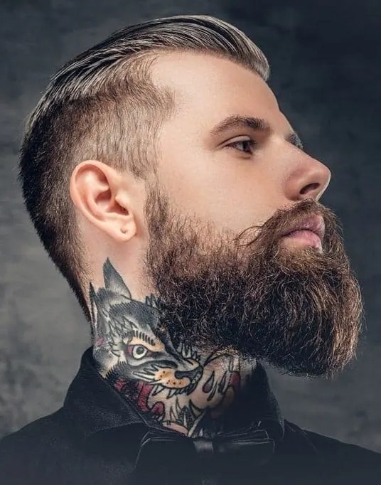 Profile of tattooed man with full neck beard