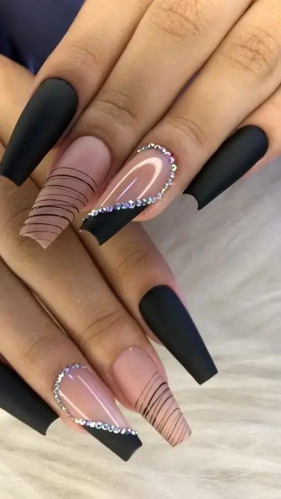 One of this year's trends is a combination of black and gold nail designs and rings.