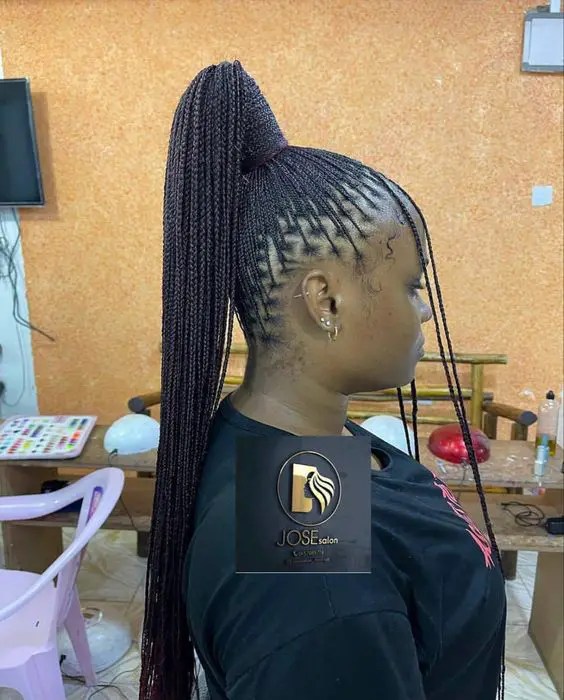 Woman showing off tiny braids in a ponytail