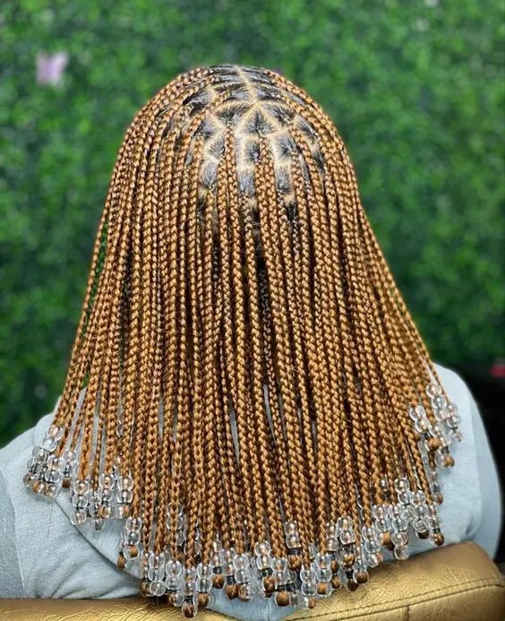 Backview of woman rocking beaded and honey braid