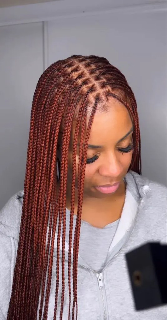 The women show off their burgundy braids in the middle.