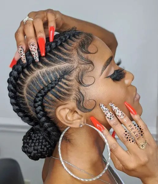 A woman wearing all-back cornrows in a bun