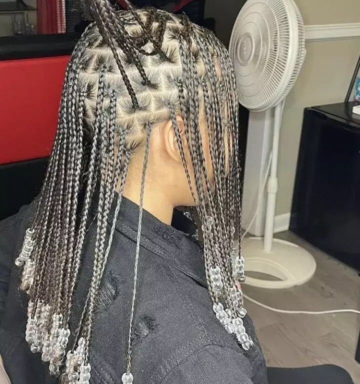 Woman shows off her beautiful knotless braids with beads