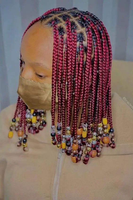 A woman wearing a mask and showing her hairstyle