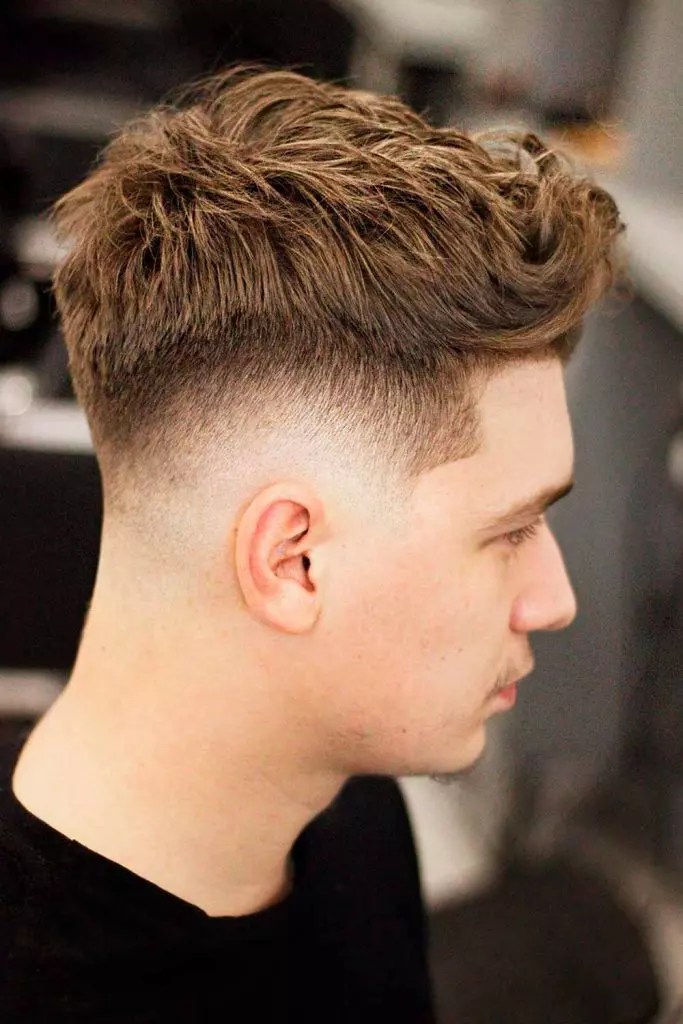 Side view of a fully puffed quiff look paired with a medium fade haircut